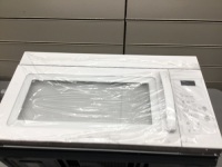White Microwave Hood Combination. Appears New With Dent on Side. Tested
