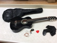 Black Guitar With Strings, Tuner, Pick, Strap, and Case. Some Damage. E-Commerce Return. See Pictures
