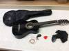 Black Guitar With Strings, Tuner, Pick, Strap, and Case. Some Damage. E-Commerce Return. See Pictures