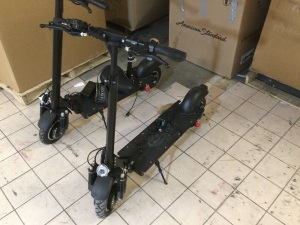 Lot of (2) Hevy Duty Electric Scooters. One Appears to have been Wtrecked and does not roll right, also it has a busted charger. The other one has stripped gears. Both Scooter Power On.